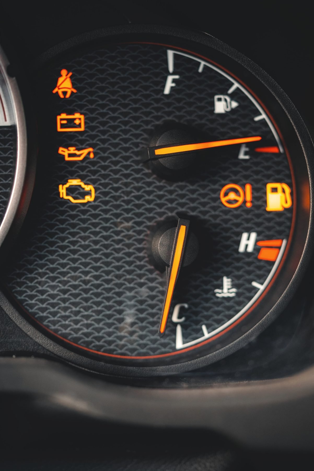 An instrument cluster with several amber warning lights lit
