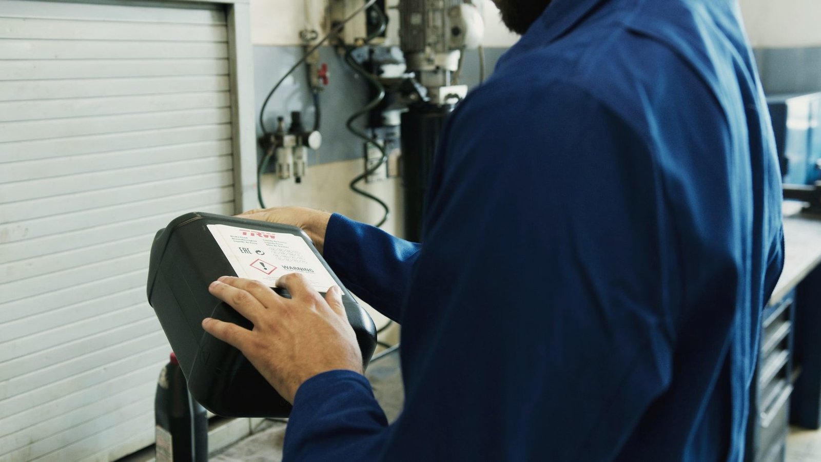 A mechanic holding a handheld diagnostic scan tool