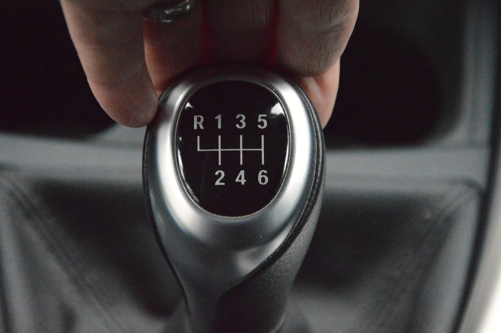 A hand on a six-speed manual gear knob